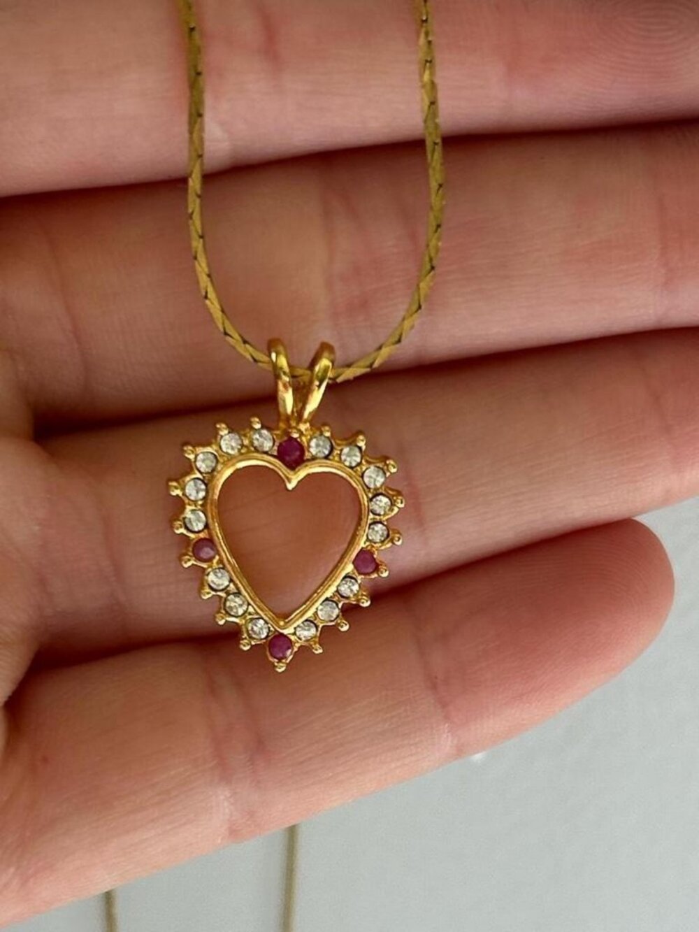 Gold tone heart necklace with rhinestone details